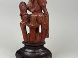 an old wooden statue of a man and woman on a horse