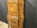 an old wooden cabinet with a marble top on a wooden floor