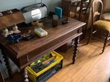 a table with a sewing machine on it in a room