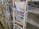 many old ladders that are leaning against the wall