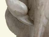 a statue of a bird that is sitting on top of a table