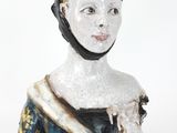 a figurine of a woman wearing a blue dress