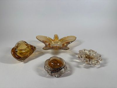 four pieces of glass sitting on top of a table next to each other
