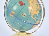 a blue and yellow globe on a stand on a white surface
