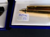 a pen and a ballpoint pen in a box
