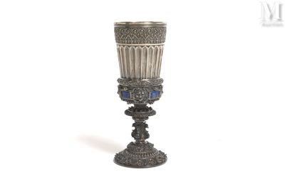 a silver cup that is sitting on top of a table