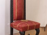 a red and black chair with a red upholstered seat