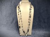 a close up of a necklace on a mannequin display