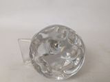 a clear glass object on a table with a white background