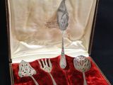 a box with silverware in it on a black background