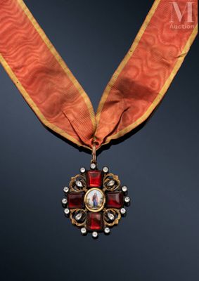 a close up of a medal with a red ribbon around it