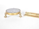 a close up of a small brass object on a white surface
