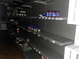 many empty shelves in a store that are full of items