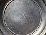 a silver plate that has a small logo on it