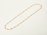 an image of a gold necklace on a white background