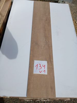 a piece of plywood sitting on the ground next to a piece of wood