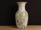 a white vase with a painting on it sitting on a table