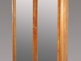 an image of a wooden cabinet with a mirror on top of it