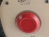 a close up of a red button on a black and white machine