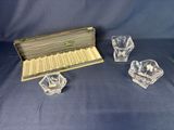 a set of four glass ashtrays and a box