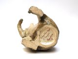 a small figurine of a cat on a white surface