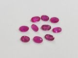 a group of pink sapphires on a white surface