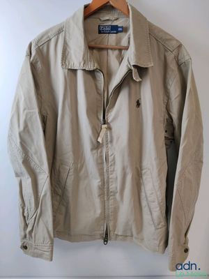 an image of a jacket hanging on a hanger on a wall