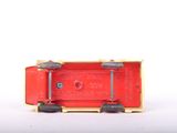 a red toy car with wheels on a white surface