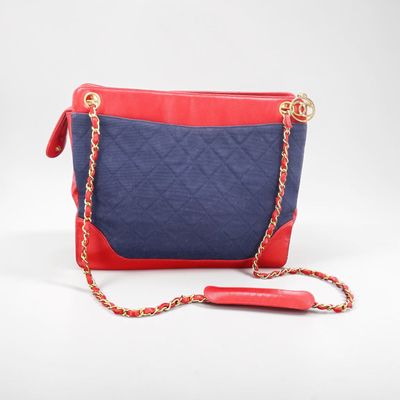 a red and blue purse with a chain strap