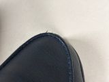 a close up of a pair of black shoes on a white surface