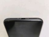 an apple iphone sitting on top of a table next to a white wall