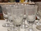 a lot of glasses sitting on a table in a room