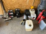 many different types of gas cans and tools in this garage