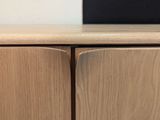 a close up of a wooden cabinet with a black object on top of it