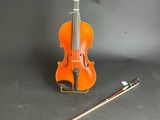 a violin and a violin stick on a table