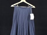 a skirt hanging on a clothes rack with a tag on it
