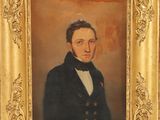 painting of a man in a suit and bow tie in a gold frame