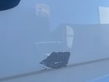 a white truck with a hole in the side of it