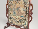 an old wooden frame with a tapestry hanging on it