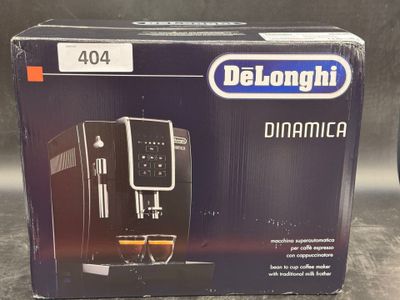 the box of the delonghi coffee machine is open on the table