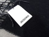 black and white photo of a black scarf with a tag on it