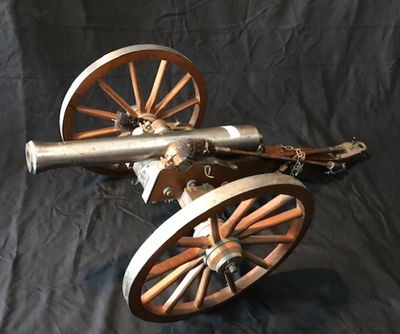 an image of a cannon on wheels on a black background