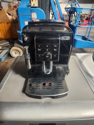 a black coffee machine sitting on top of a table