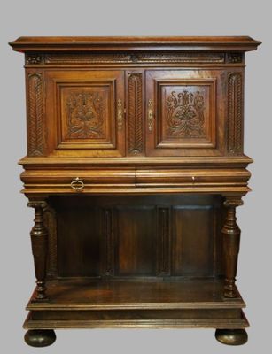 an old wooden cabinet with carvings on the top of it