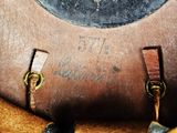 a close up of a brown leather bag with writing on it