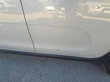 a picture of a white car parked on the side of the road