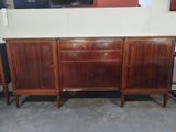 a wooden sideboard with two drawers and two doors on each side