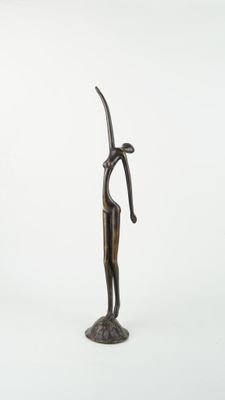 bronze statue of a woman holding a knife on a white background