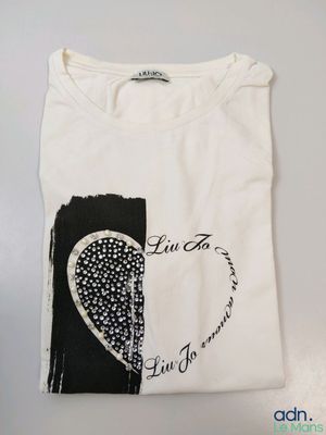 a white t - shirt with a black and white heart on it