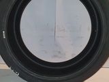 a close up of a tire on a counter with a wall in the background